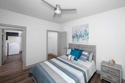 Modern bedroom with laundry area in the background