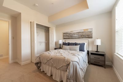 A well-furnished private bedroom in a senior living facility.