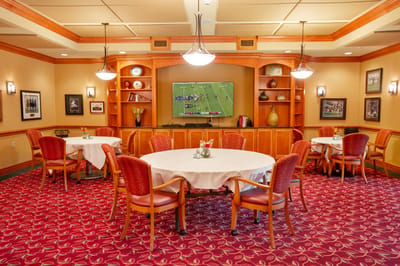 Dining area with tables and a television in a cozy setting