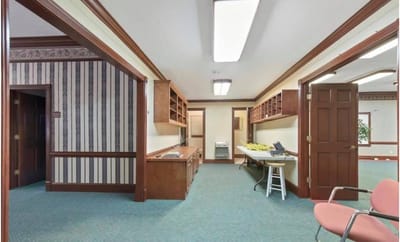 Interior view of a facility hallway with desks