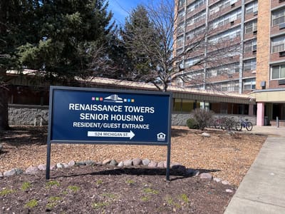 Sign displaying the facility name and entrance information
