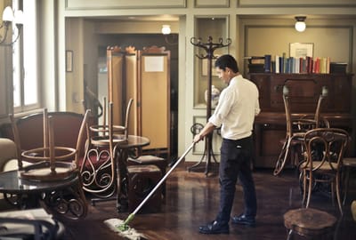 Staff member cleaning a common area in the facility