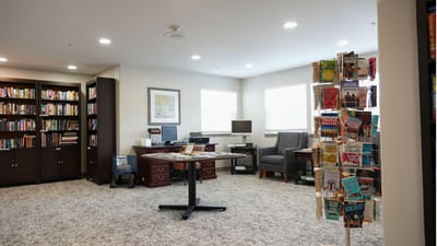 A cozy library with bookshelves and seating