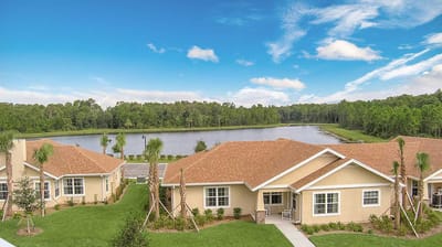 Aerial view of a senior living facility by a lake