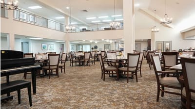 Bright dining room with tables set for meals