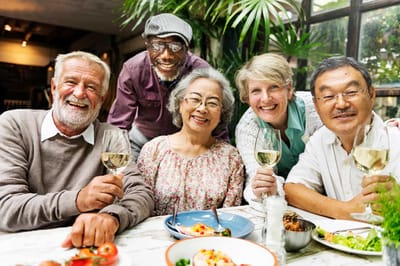 Group of smiling residents enjoying a meal together