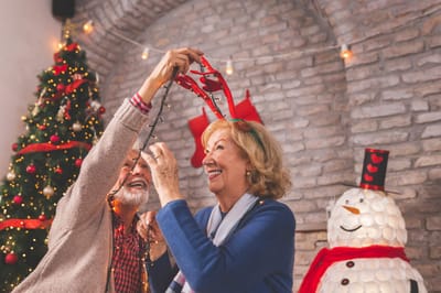Residents celebrating with holiday decorations indoors