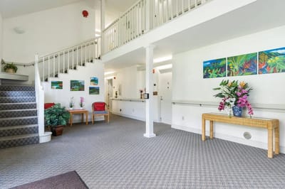 Bright lobby area with plants and artwork