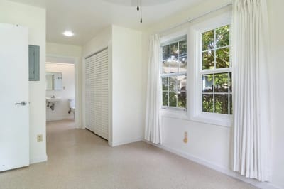 Bright interior room with windows and neutral walls