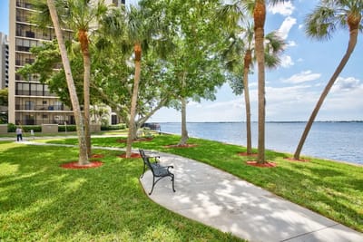 Lush outdoor space with a waterfront view and seating