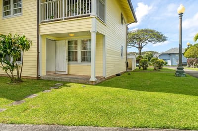 Exterior view of a senior living facility with green lawn