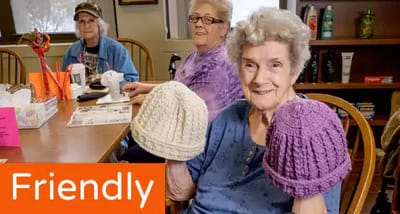 Residents participating in a crafting activity in a common area