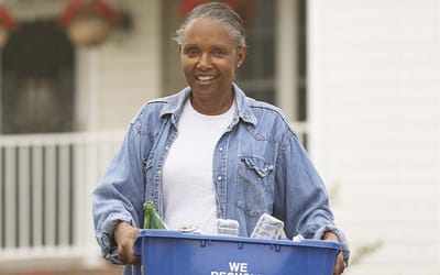 Woman participating in recycling activities outside a building