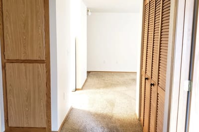 Interior of a private room with carpet and closet doors