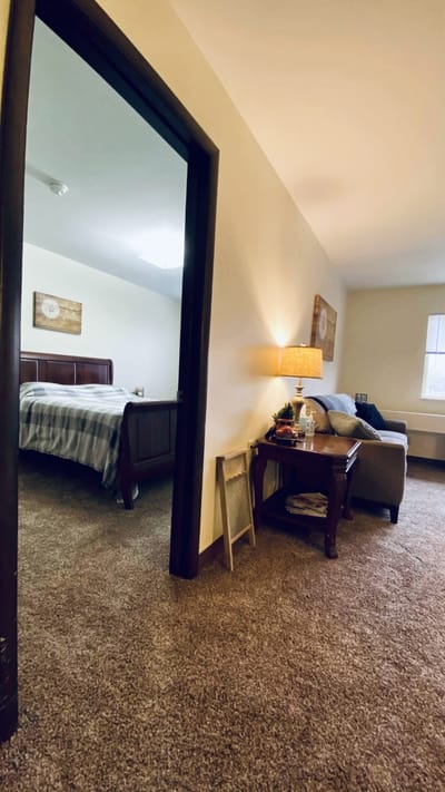 Cozy resident room with a bed and seating area