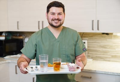 Staff member serving food in a dining area