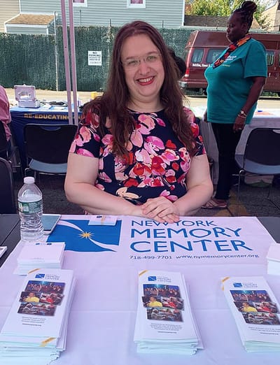 Staff member at a table with brochures