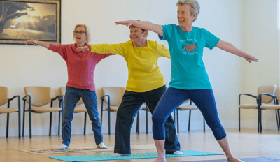 Residents participating in a yoga class in a communal space