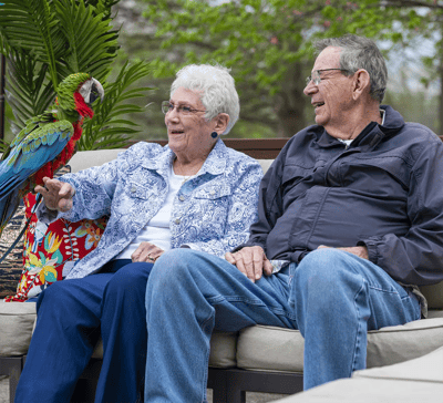 Residents enjoying time outdoors with a parrot