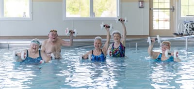 Residents participating in aquatic exercise in a pool