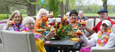 Residents enjoying a festive outdoor gathering with drinks
