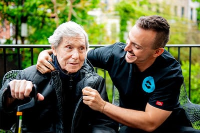 Caregiver helping a resident outdoors