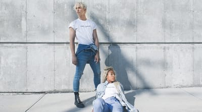 Two young adults posing in an urban setting