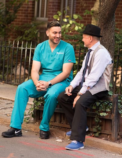 A caregiver chatting with a resident outside