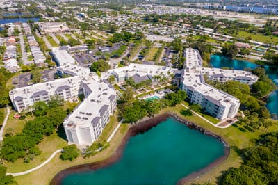Aerial view of a senior living facility surrounded by water