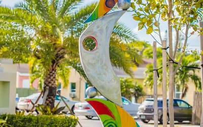 Colorful outdoor art installation surrounded by palm trees