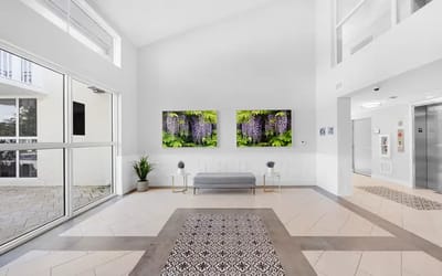 Bright lobby area with floral artwork and seating