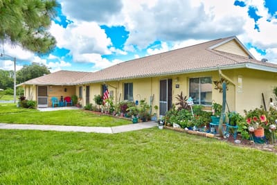 Exterior view of a senior living facility with gardens