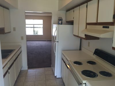 Kitchen view with appliances and entry to another room
