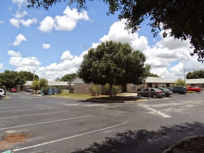 Exterior view of Park Place Apartments with parking
