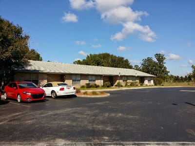 Exterior view of a senior living facility with parking