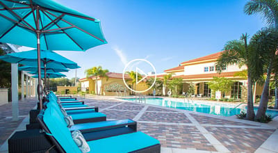 A bright outdoor pool area with lounge chairs