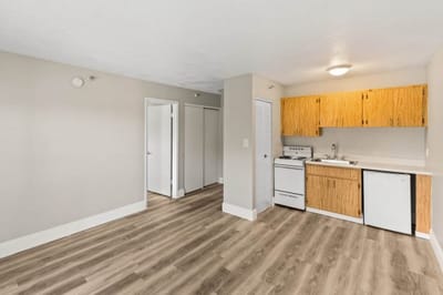 Interior view of a small kitchenette and living area in a resident room