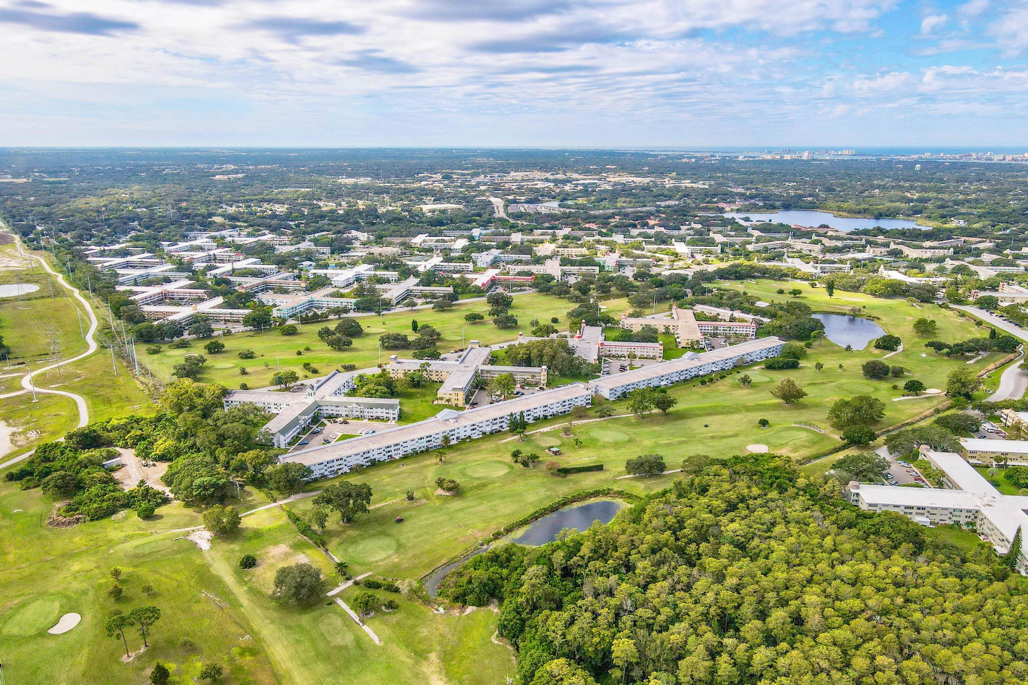 Aerial view of a large senior living community surrounded by greenery