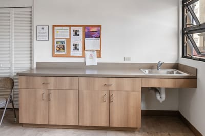 Interior space with a kitchenette and bulletin board