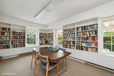 Bright library area with bookshelves and table