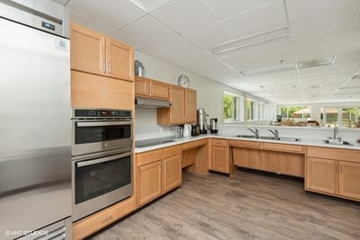 Interior view of a large kitchen space with wooden cabinets