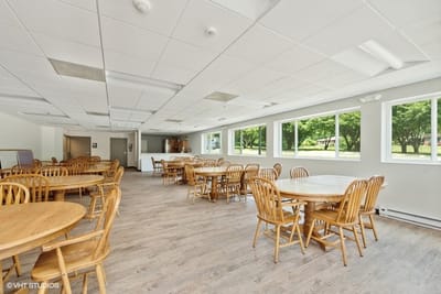 Bright common area with wooden tables and chairs