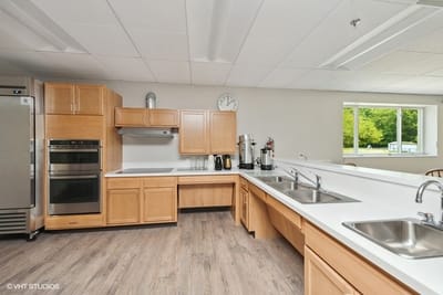 Modern kitchen area with wooden cabinets and appliances