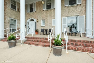 Exterior entrance with pots and seating area