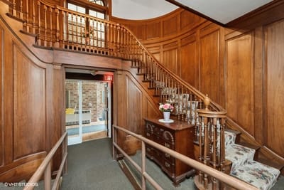 A warm and inviting interior staircase in a senior living facility