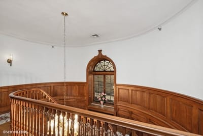 Interior view of a staircase with wooden railing