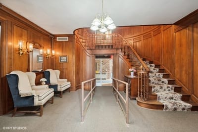 Interior view of a lobby with a staircase and seating area