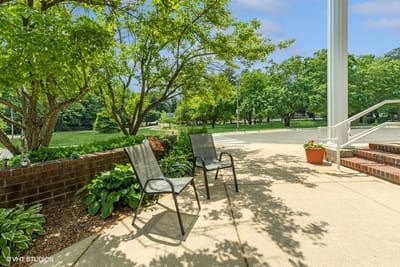 Outdoor seating area surrounded by greenery