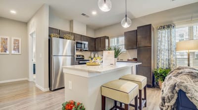 Modern kitchen interior with stainless steel appliances and dining area