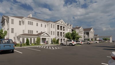 Exterior view of Traditions of Westfield with residents and vehicles